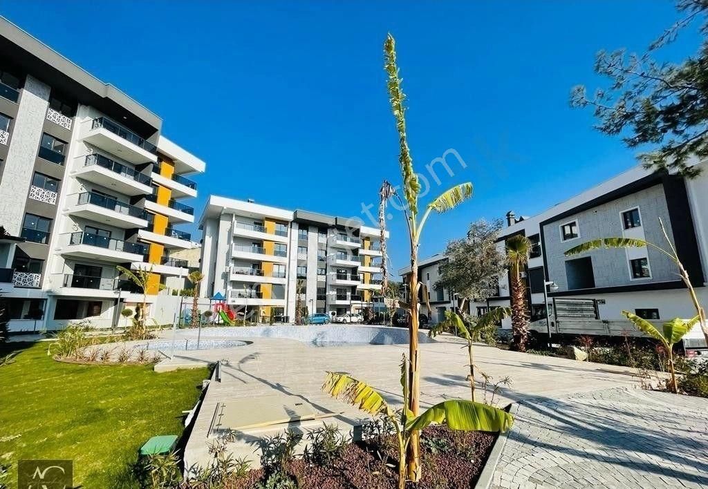 Kuşadası İkiçeşmelik Satılık Daire GUVENLIK-ACIK/KAPALI HAVUZ-OTOPARK-HAMAM-SAUNA-YERDEN ISITMA-YENİ-LÜX-FIRSAT DAİRELER