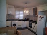 Kuşadasında Havuzlu Güvenlikli Bahçe Katı Eşyalı 2+1