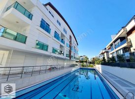 Lara Güzeloba'da Havuzlu,k.otopaklı Site İçersinde Eşyalı 1+1