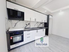 Denizden Akçayda Kapalı Otoparklı Yerden Isıtmalı Satılık 1+1 Daire.