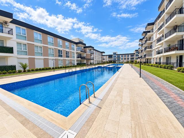 Kuşadası İkiçeşmelik 2+1 Havuz Cepheli Bahçe Katı Daire 1